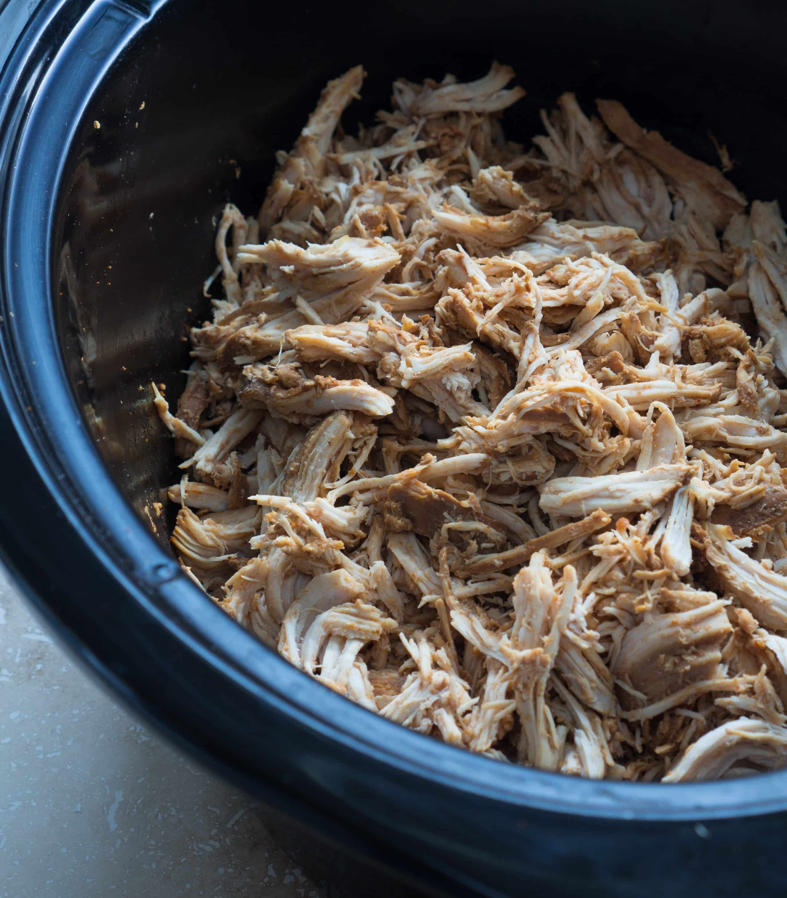 Easy Crockpot Pulled Chicken - This gluten-free recipe for Easy Crockpot Pulled Chicken is easy eats! Lean, protein-packed chicken breasts are made in the slow cooker with apple cider vinegar, tomato sauce, Worcestershire sauce, molasses, and smoked paprika. We love using this tender shredded chicken in enchiladas, tacos, lettuce wraps, sandwiches, and salads ♥ | freeyourfork.com