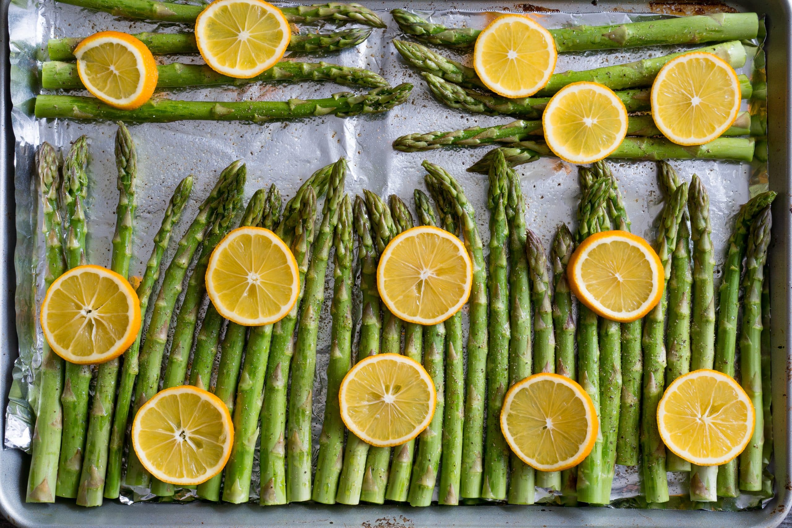 Baked Lemon Pepper Asparagus – Simple recipe for Baked Lemon Pepper Asparagus using fresh asparagus, extra virgin olive oil, salt, pepper, and fresh lemon slices. All you need is a hot oven, 5 ingredients, a sheet pan, and 20 minutes. We love making this part of our healthy weekly meal prep! Gluten free, vegan, & paleo-friendly. ♥ | freeyourfork.com