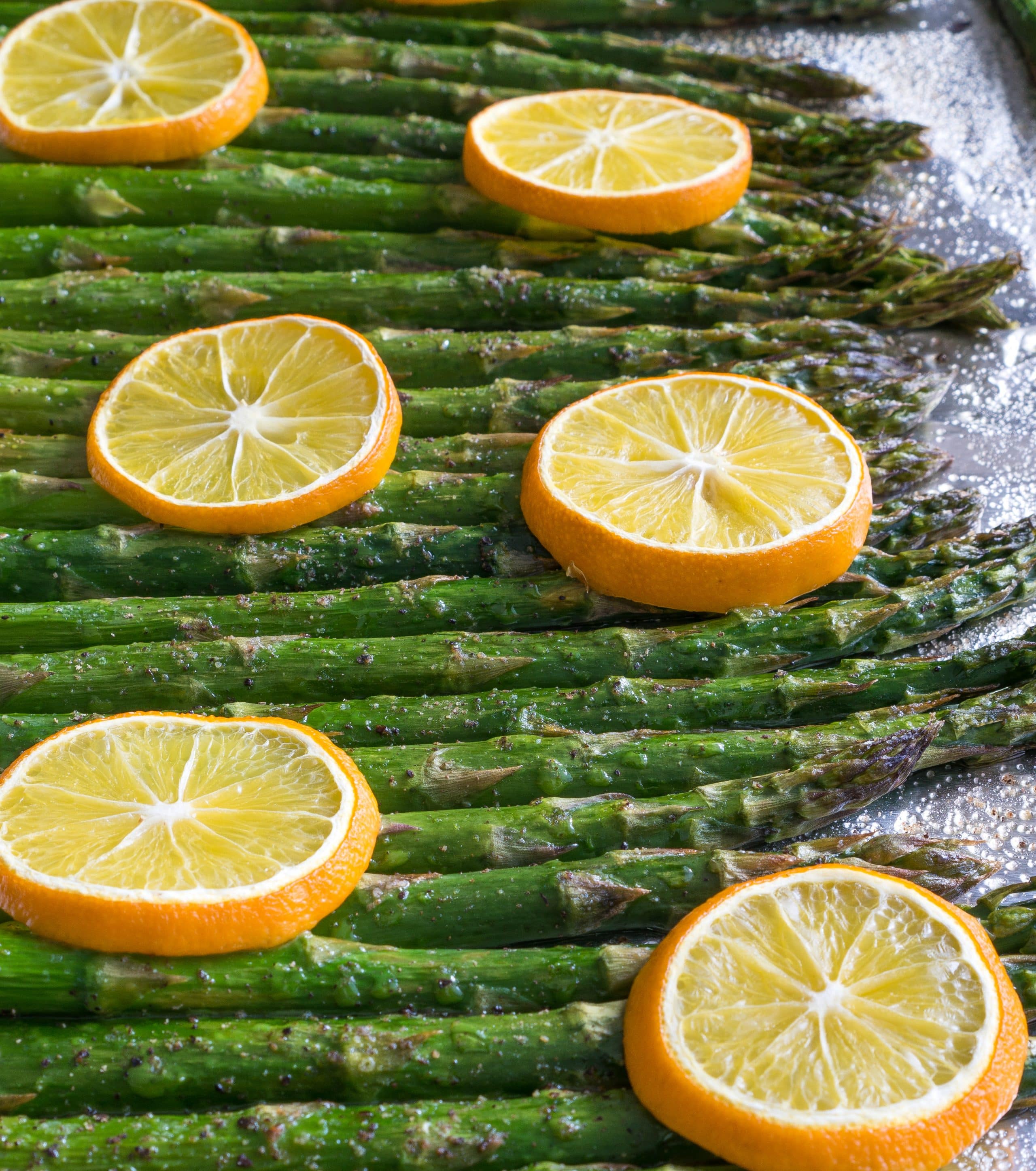 Baked Lemon Pepper Asparagus – Simple recipe for Baked Lemon Pepper Asparagus using fresh asparagus, extra virgin olive oil, salt, pepper, and fresh lemon slices. All you need is a hot oven, 5 ingredients, a sheet pan, and 20 minutes. We love making this part of our healthy weekly meal prep! Gluten free, vegan, & paleo-friendly. ♥ | freeyourfork.com