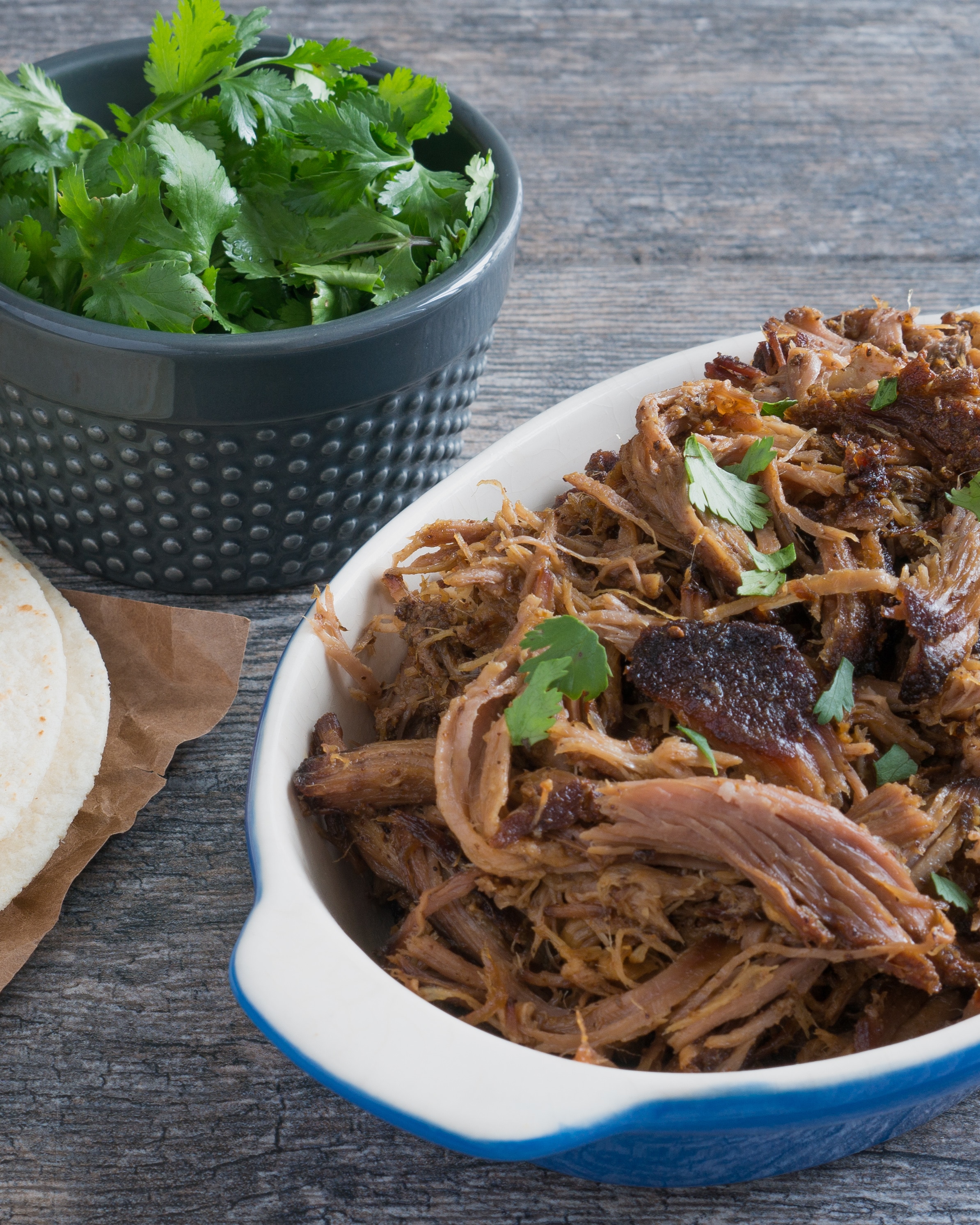 Crispy Crockpot Carnitas – Easy recipe for homemade Crispy Crockpot Carnitas. Gluten-free and paleo-friendly! Perfect for tacos, burritos, nachos, enchiladas, sandwiches, and more! Just combine pork shoulder with a simple dry-rub & a squeeze of citrus, then let your slow cooker do the rest. We love this on top of eggs for a quick, savory breakfast! ♥ | freeyourfork.com