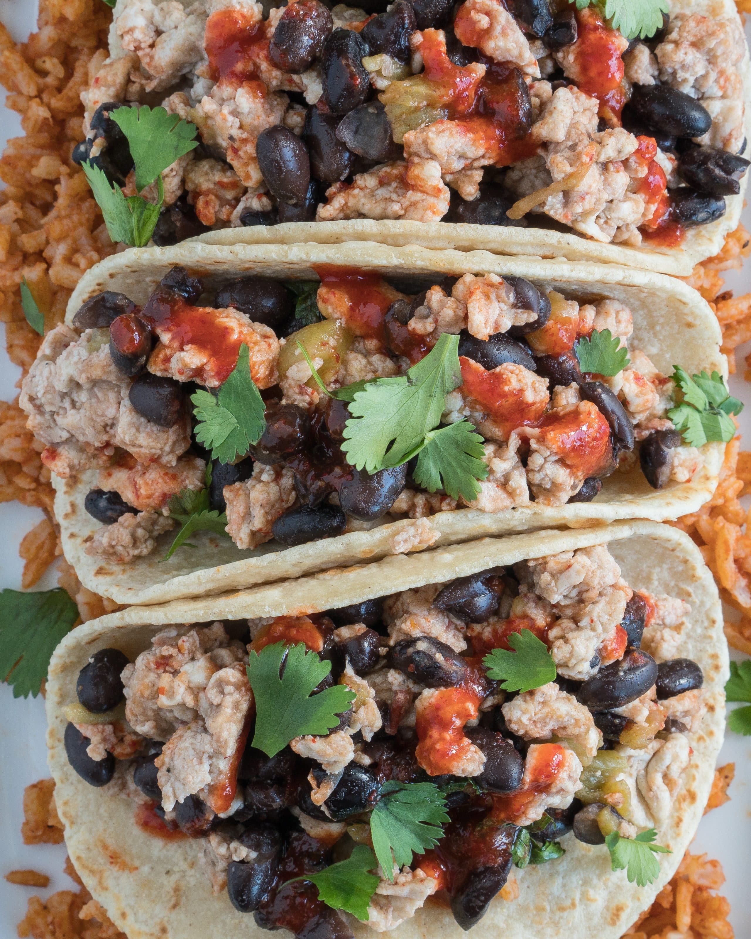 Southwestern Breakfast Tacos – Simple, healthy recipe for Southwestern Breakfast Tacos! This high-protein brunch dish uses egg whites, green hatch chiles, black beans, and shredded cheese with flavors of tomato, coriander, & chili garlic paste. We love that this gluten-free & vegetarian friendly recipe comes together in just 10 minutes! ♥ | freeyourfork.com