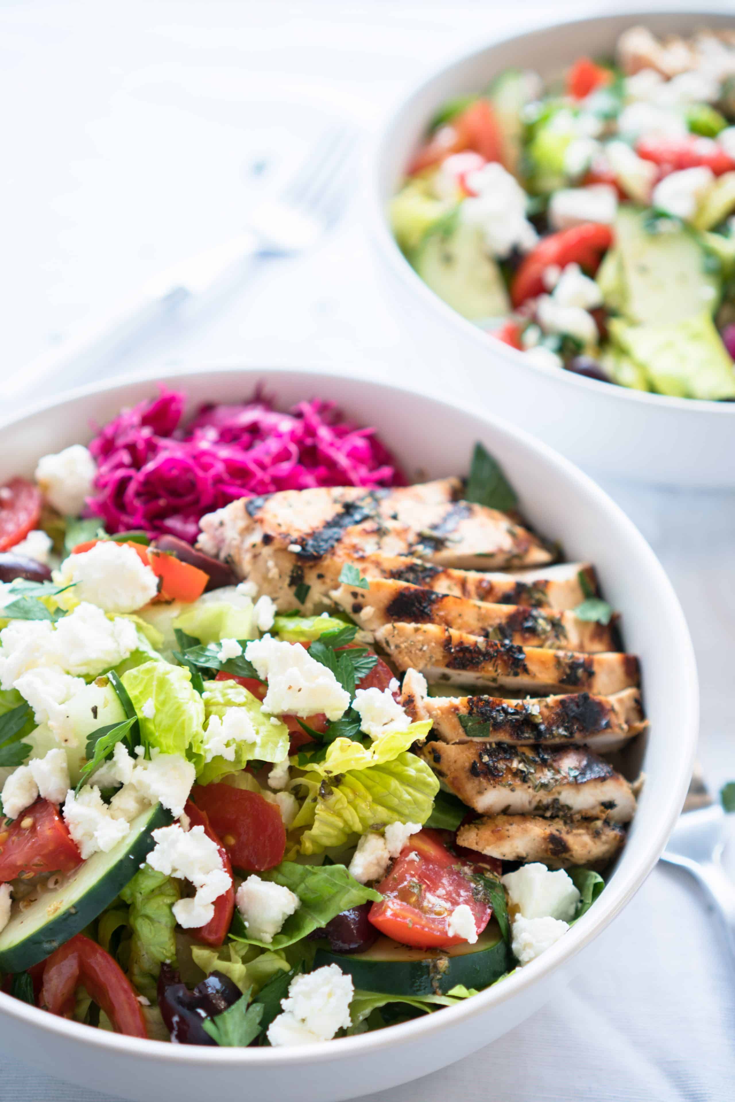 Mediterranean Salad Bowls – Simple, healthy recipe for Mediterranean Salad Bowls! Crisp romaine topped with cucumber, tomatoes, Kalamata olives, feta cheese, and homemade pickled red cabbage with a lemony Greek Dressing. Gluten-free & low carb! ♥ | freeyourfork.com