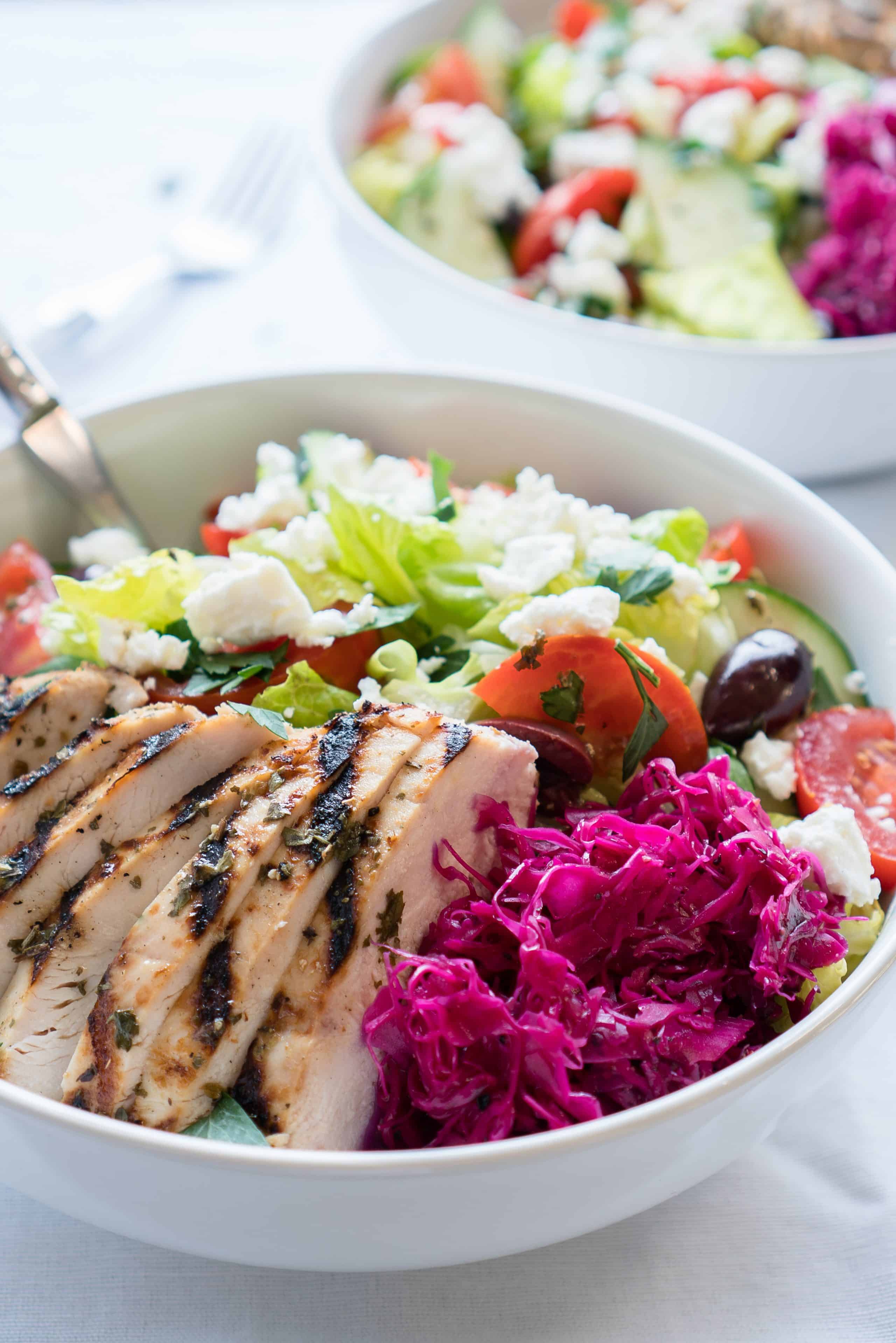 Mediterranean Salad Bowls – Simple, healthy recipe for Mediterranean Salad Bowls! Crisp romaine topped with cucumber, tomatoes, Kalamata olives, feta cheese, and homemade pickled red cabbage with a lemony Greek Dressing. Gluten-free & low carb! ♥ | freeyourfork.com