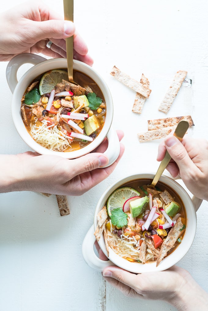 Chicken Tortilla Soup - Healthy recipe made in the instant pot using lean chicken breast, black beans, tomatoes, bell peppers, green chiles, jalapeño, corn, and more. Best served with toppings like sour cream + avocado + crisped tortilla strips! ♥ | freeyourfork.com