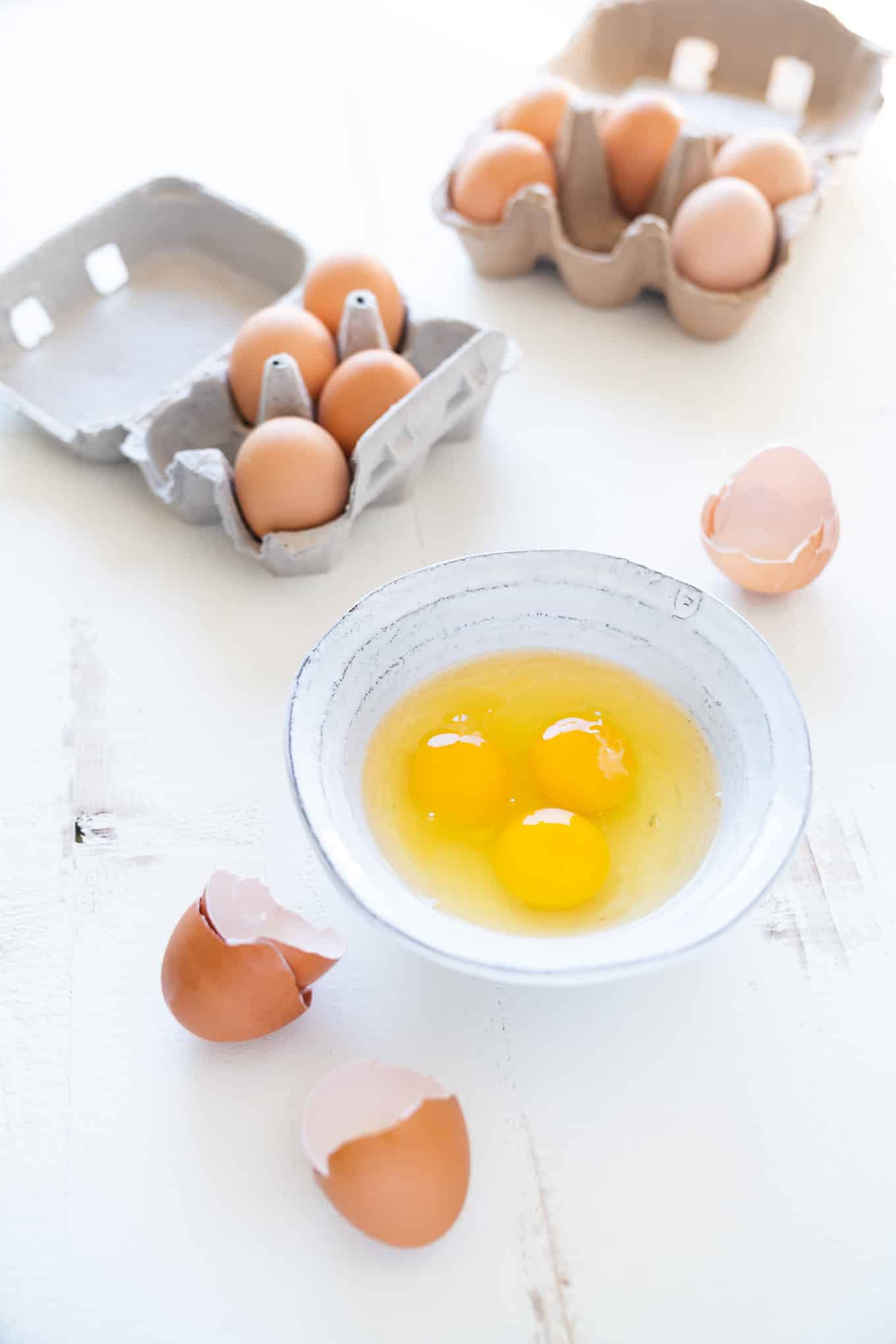 Cage-Free Free-Range Pasture-Raised Eggs - two cartons and cracked egg in bowl