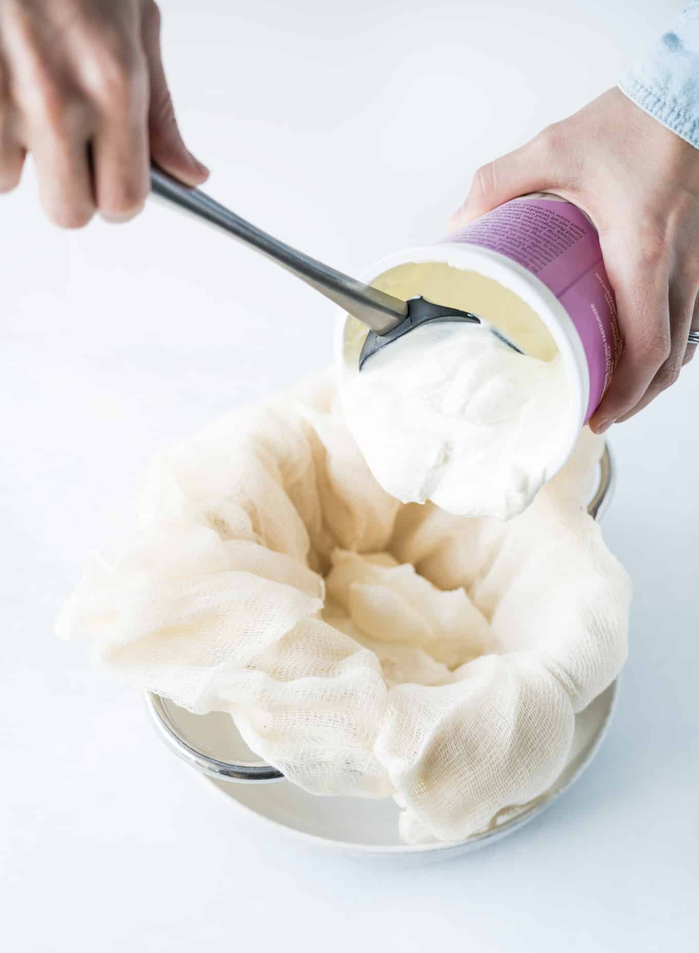 Greek Yogurt Cream Cheese pouring yogurt into strainer