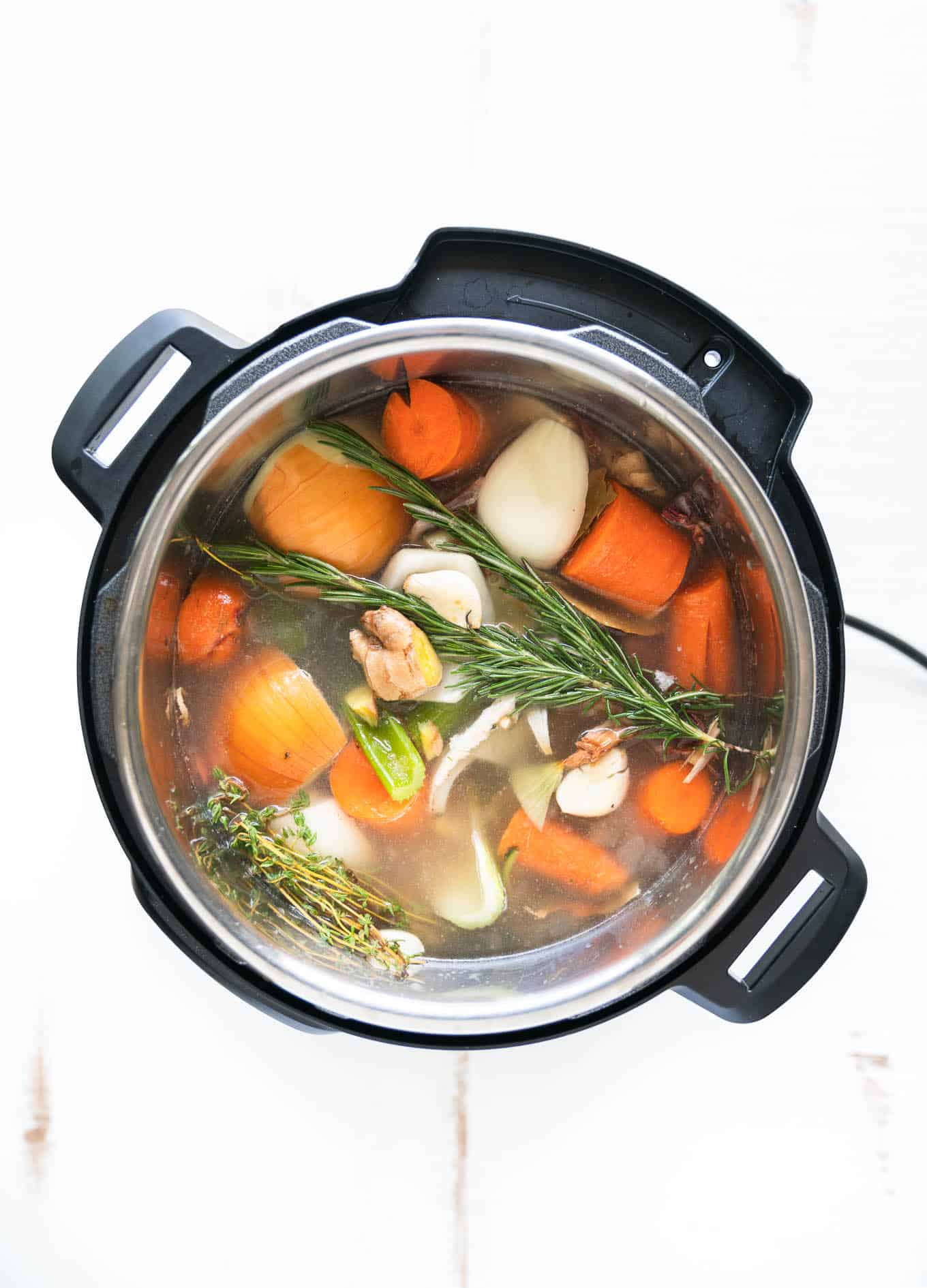 Instant Pot Bone Broth with veggies just covered in water