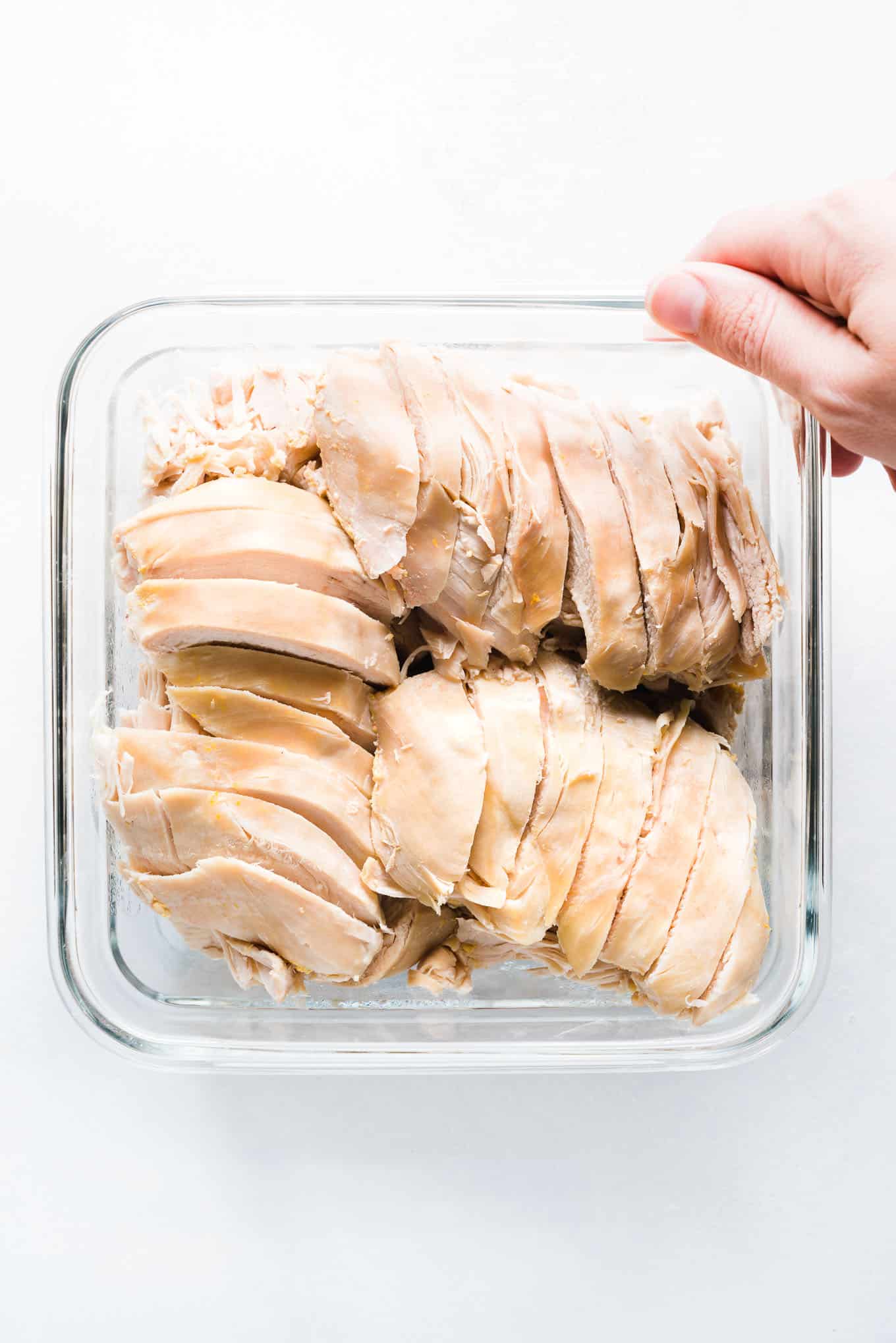Sliced chicken breast in glass square container