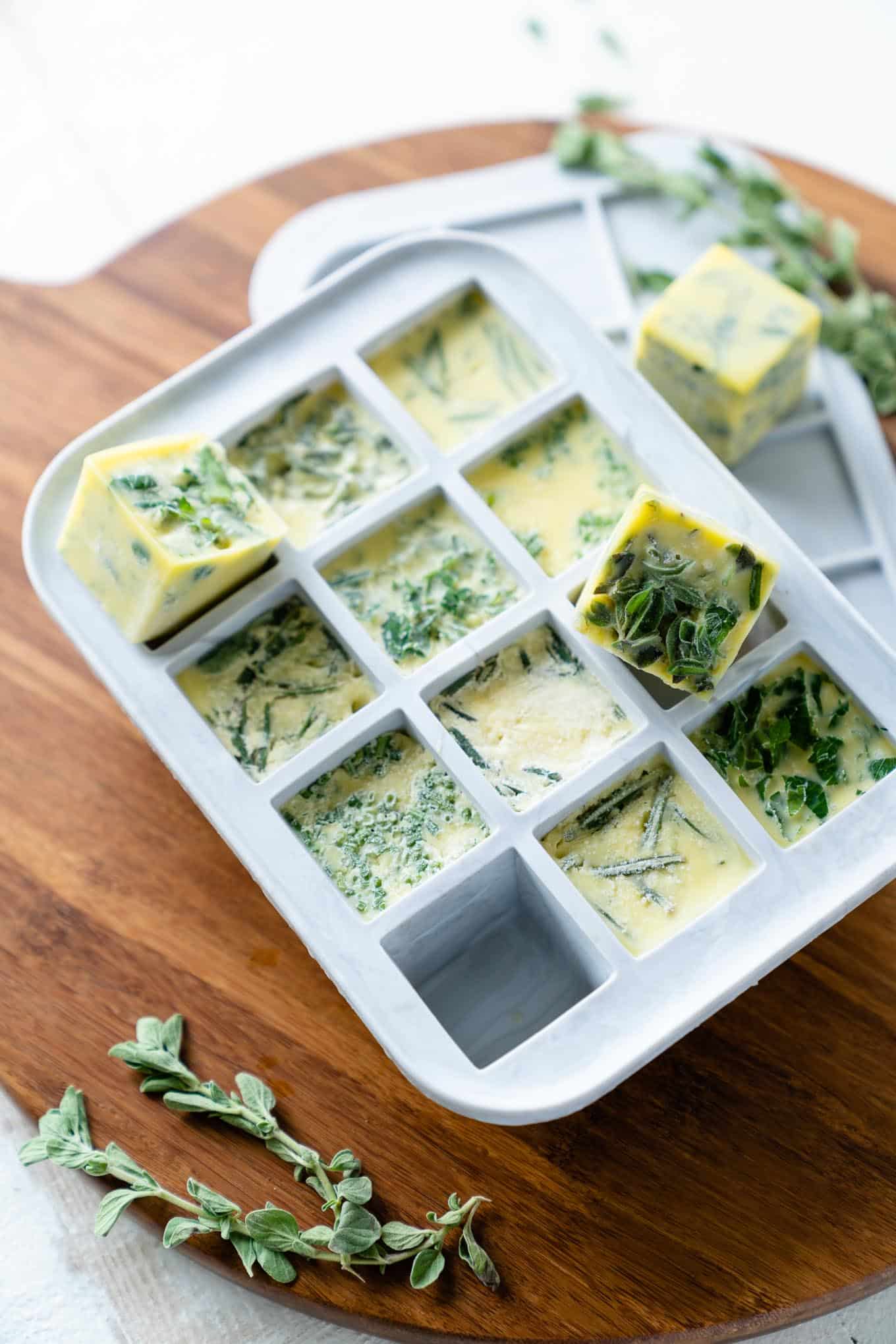 Herb Cubes popped out of white ice cube mold