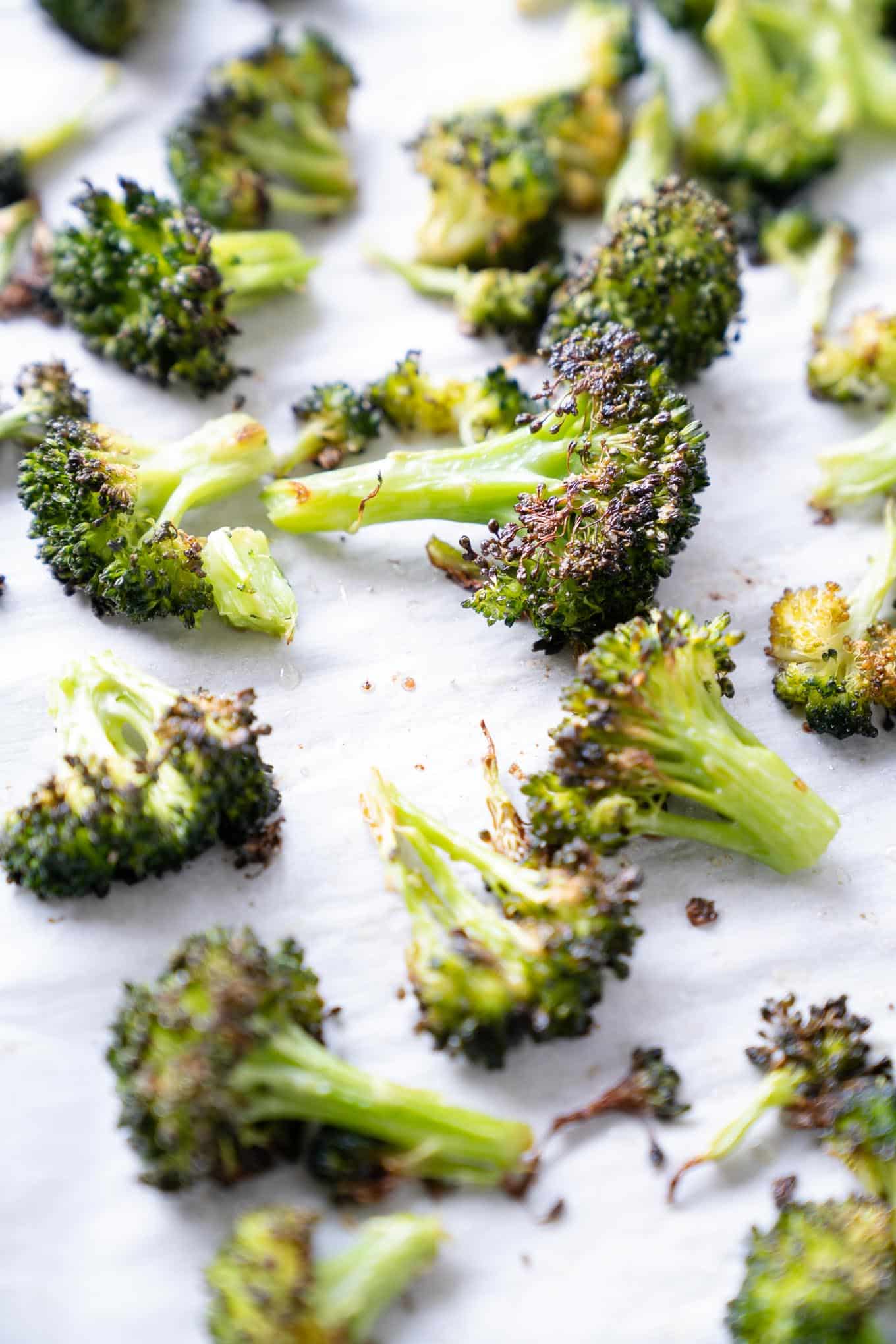 Broccoli Florets on white parchment paper lined sheet tray