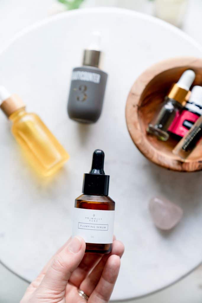 flatlay of bottles on table Best Clean Beauty Face Oils + Serums