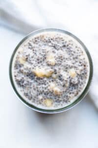 Closeup of a set chia pudding with chunks of banana mixed in.