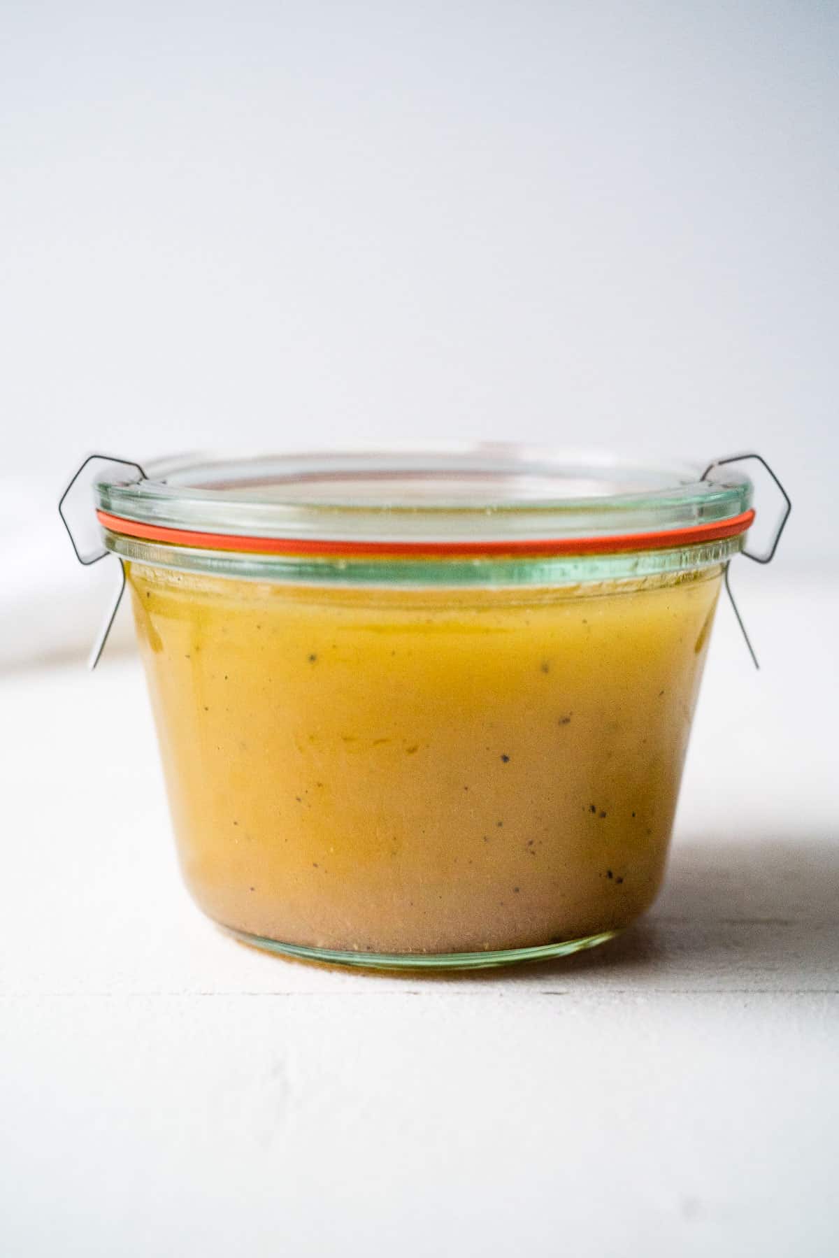 A glass weck jar filled with white balsamic vinaigrette.